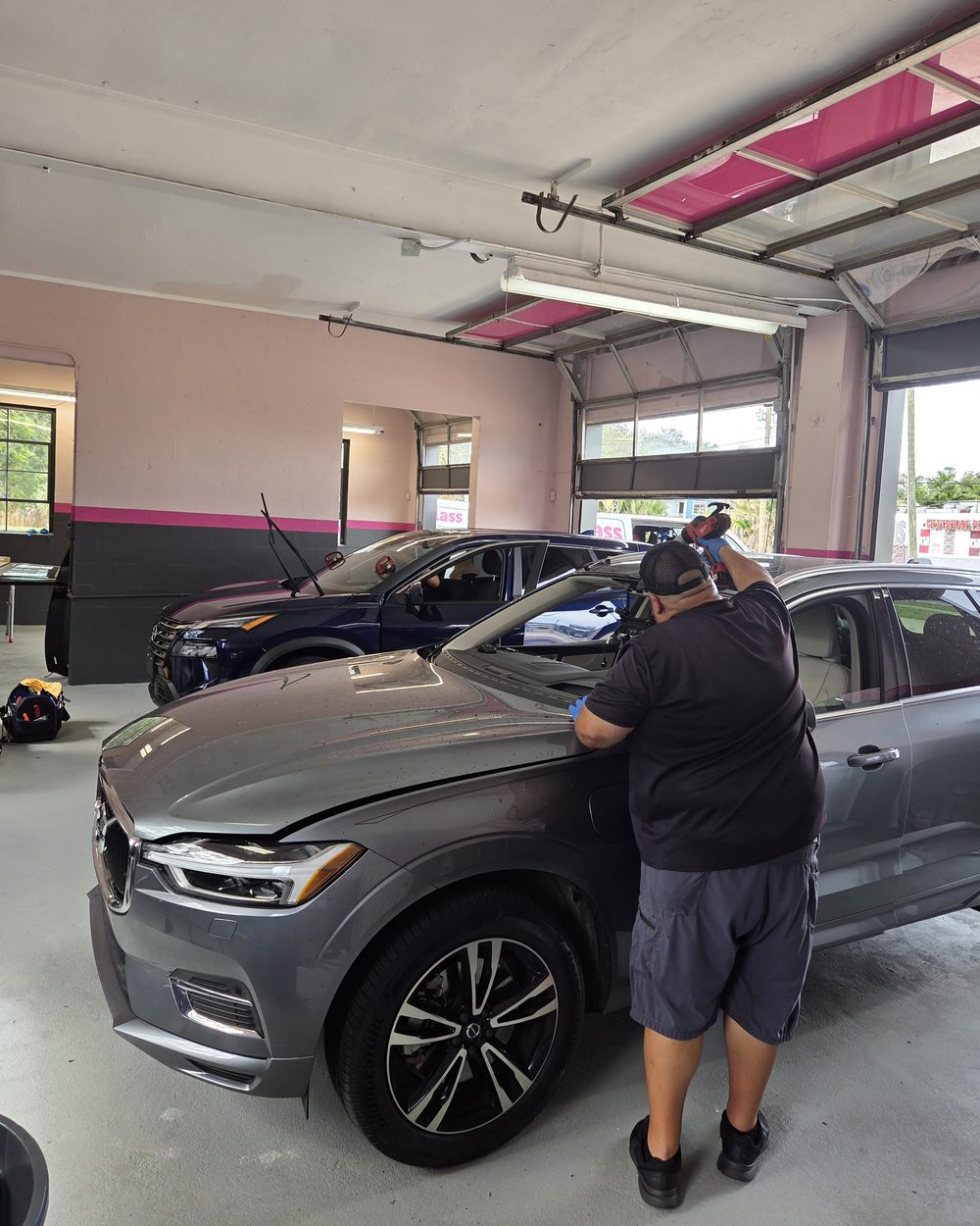 Optic-Kleer technician working on a vehicle in the Tampa shop